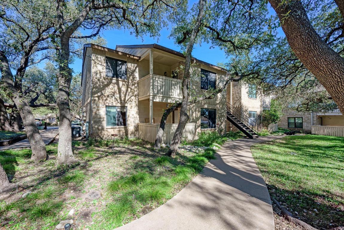 8210 Bent Tree Road, Unit 136 Austin, TX 78759 - Photo 20 of 20 View of front facade featuring a balcony, stairway, and brick siding