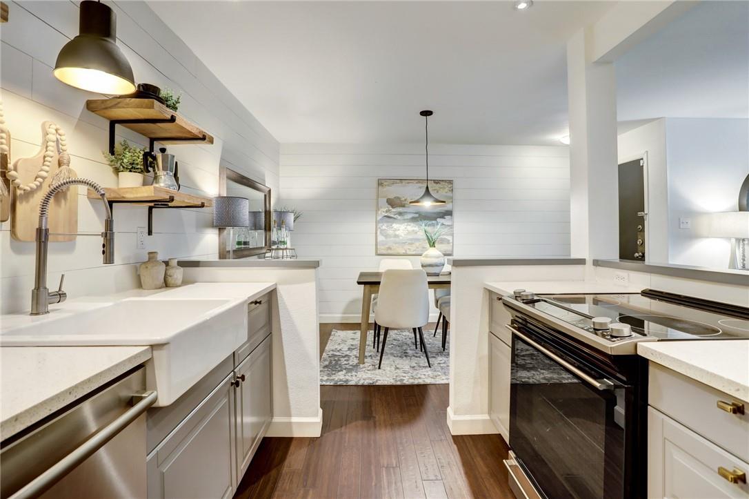 8210 Bent Tree Road, Unit 136 Austin, TX 78759 - Photo 7 of 20 Kitchen with black / electric stove, open shelves, light stone countertops, stainless steel dishwasher, and dark wood finished floors