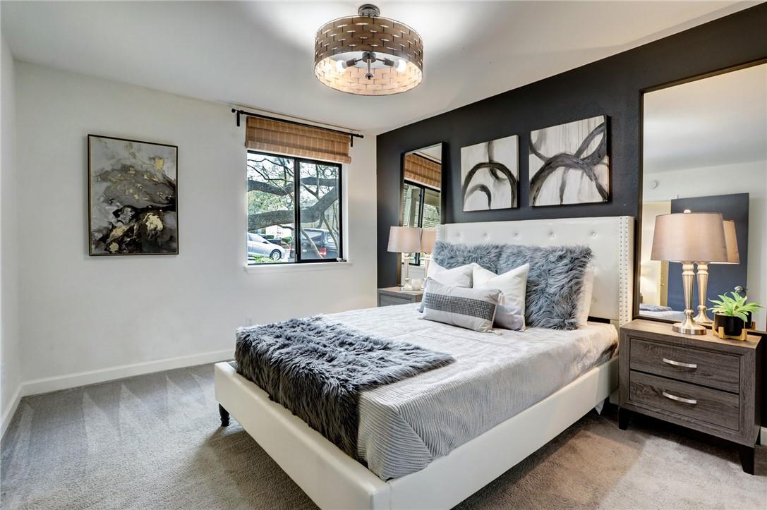 8210 Bent Tree Road, Unit 136 Austin, TX 78759 - Photo 10 of 20 Bedroom with light colored carpet and baseboards