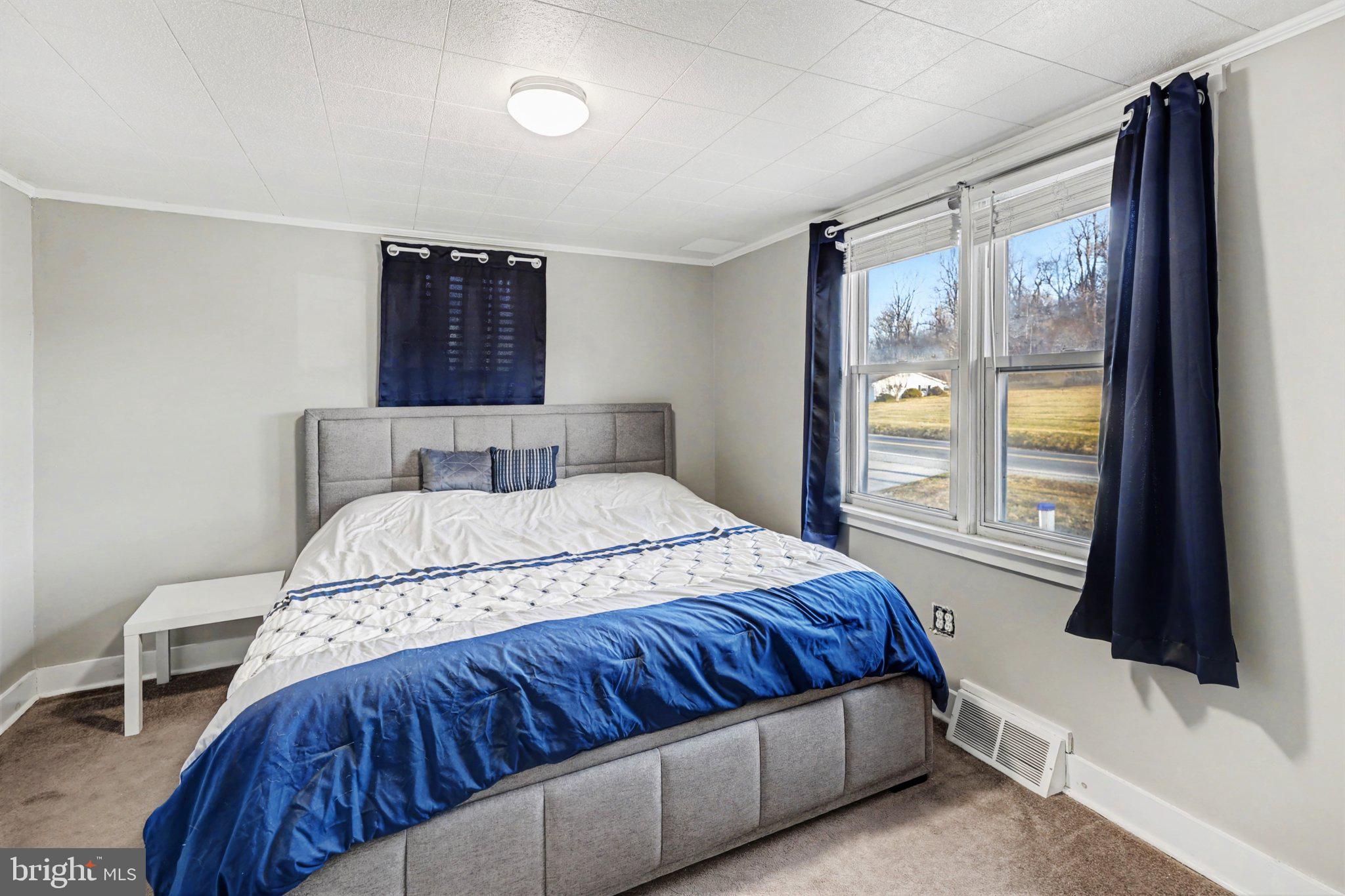 1002 Goodyear Road Gardners, PA 17324 - Photo 11 of 32 a bedroom with a large bed and a flat tv screen on dresser