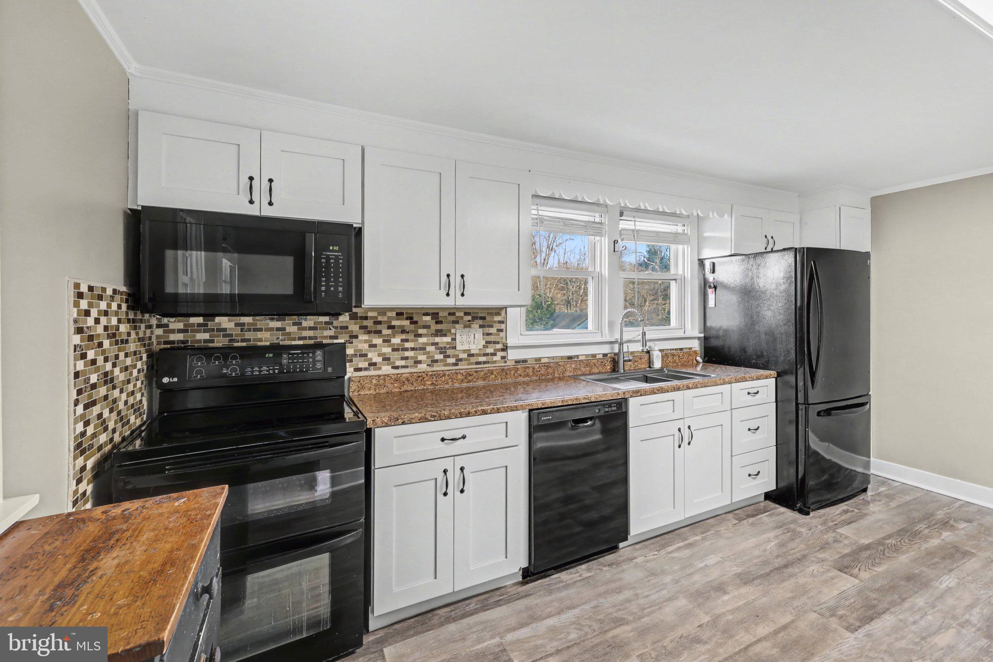 1002 Goodyear Road Gardners, PA 17324 - Photo 5 of 32 a kitchen with stainless steel appliances a stove a sink and a refrigerator