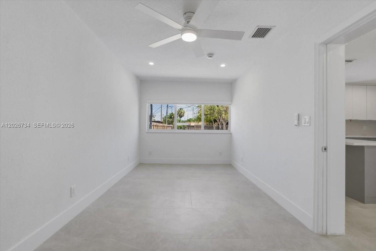 266 Southwest 6th Street Dania Beach, FL 33004 - Photo 18 of 37 an empty room with windows and ceiling fan
