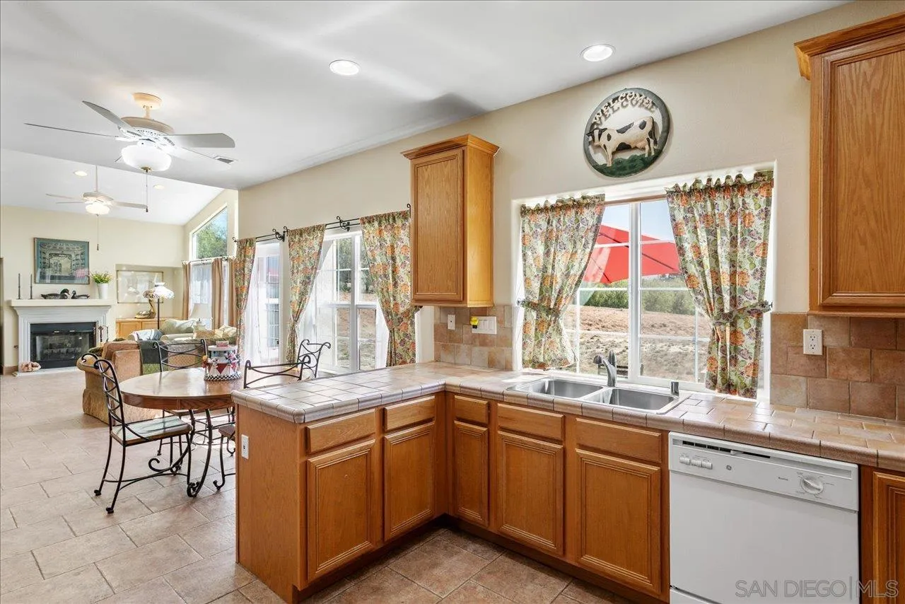 13669 Acorn Circle Valley Center, CA 92082 - Photo 11 of 33 a kitchen with a sink stove and cabinets