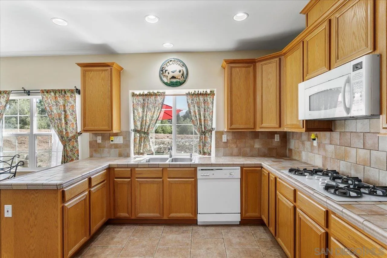 13669 Acorn Circle Valley Center, CA 92082 - Photo 13 of 33 a kitchen with a sink cabinets and window