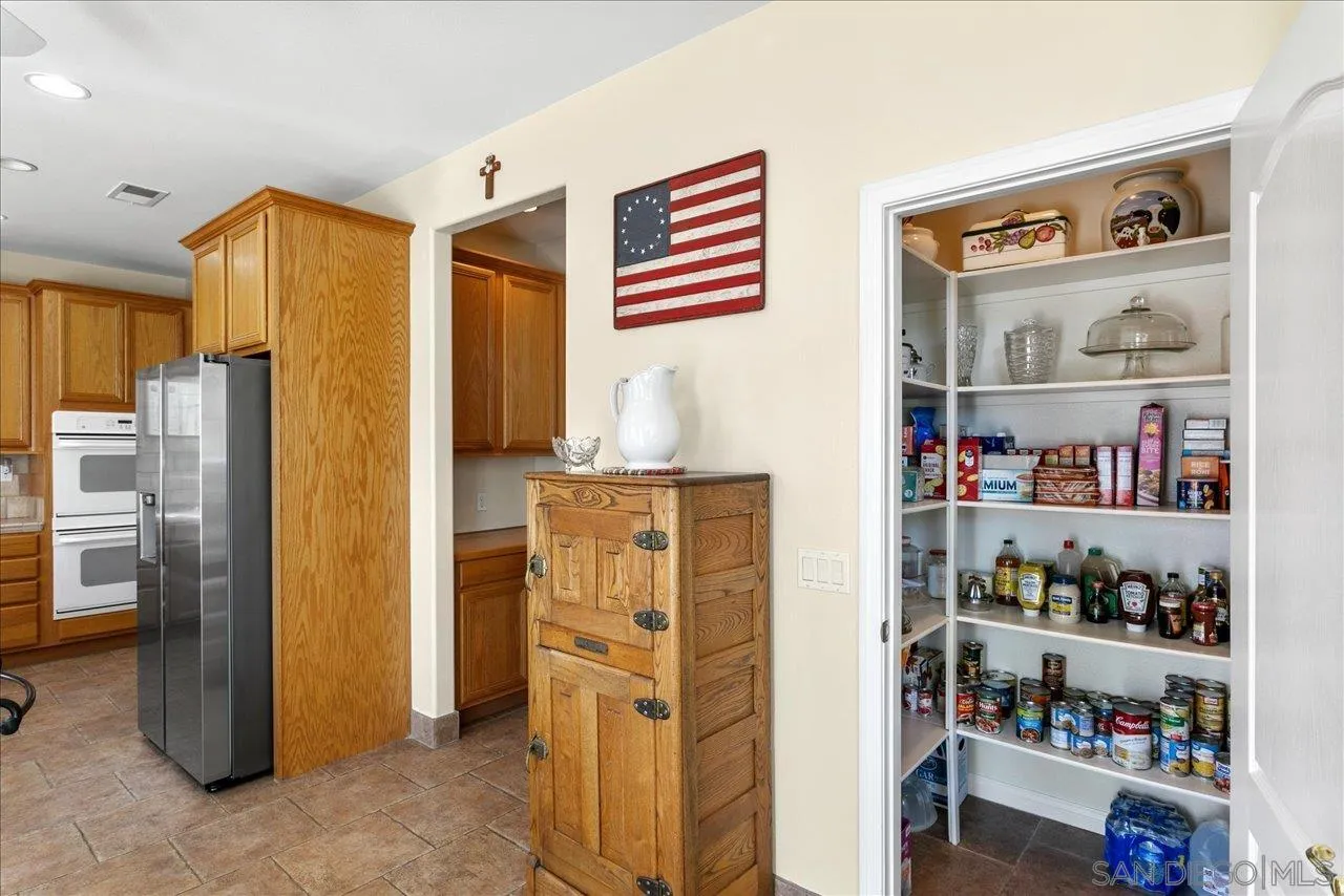 13669 Acorn Circle Valley Center, CA 92082 - Photo 15 of 33 a kitchen with refrigerator and cabinets