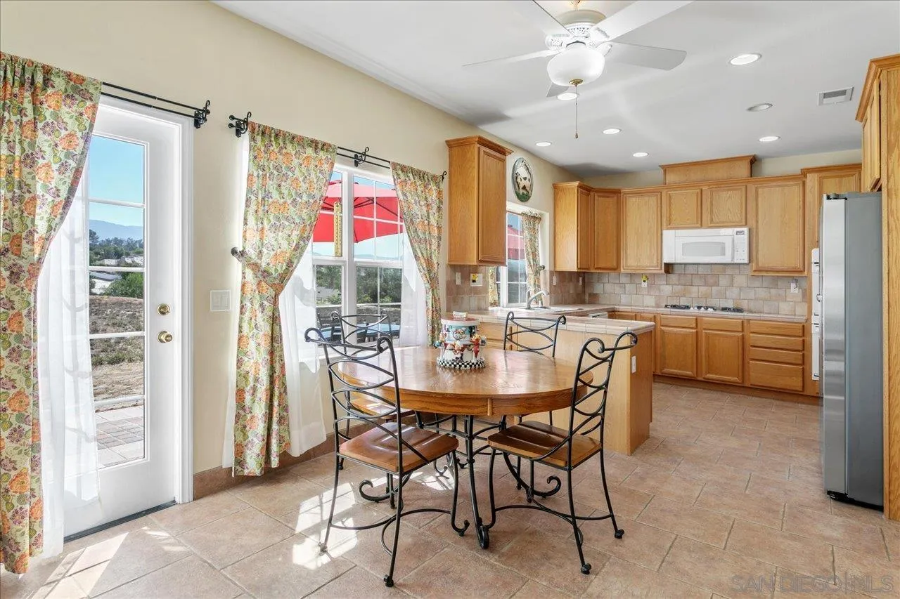 13669 Acorn Circle Valley Center, CA 92082 - Photo 20 of 33 a dining table & chairs in a kitchen
