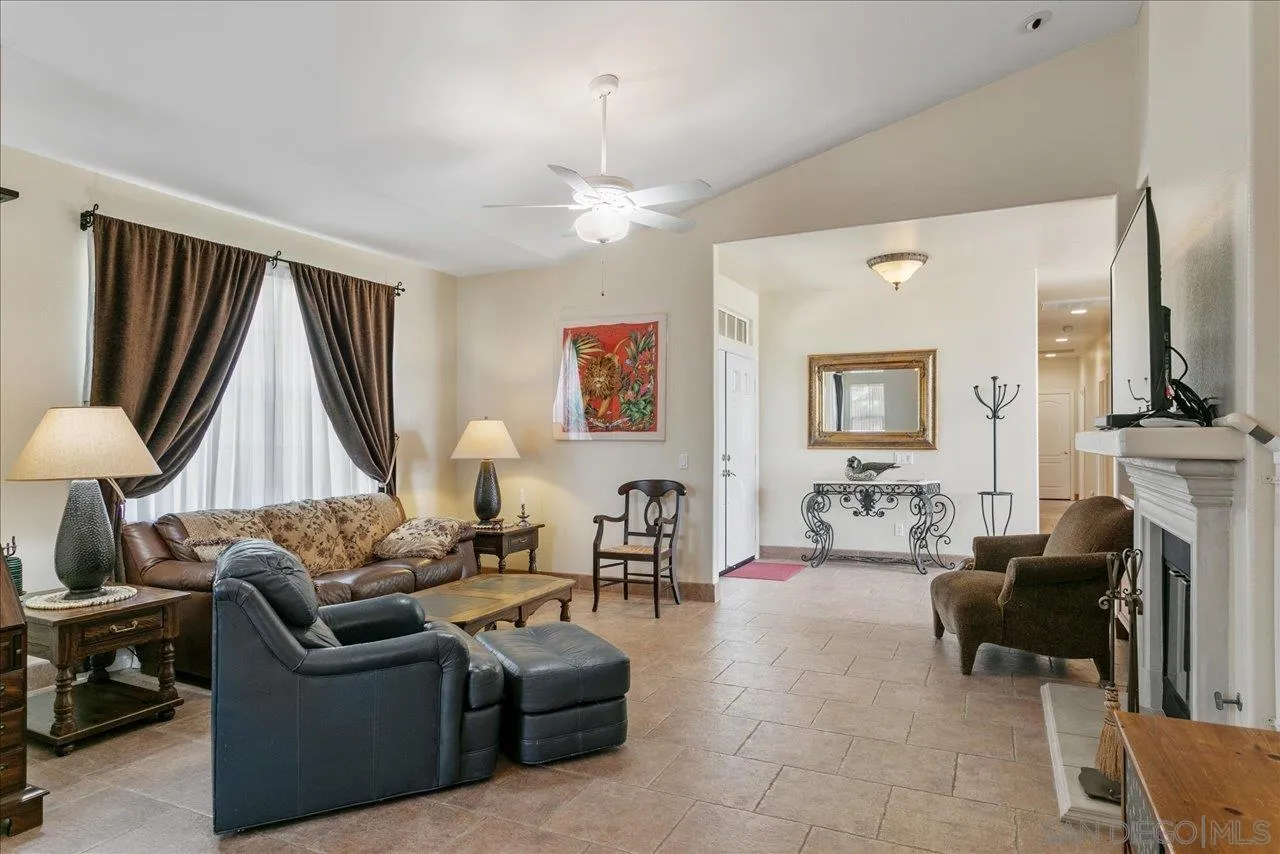 13669 Acorn Circle Valley Center, CA 92082 - Photo 23 of 33 a living room with furniture a fireplace and a chandelier