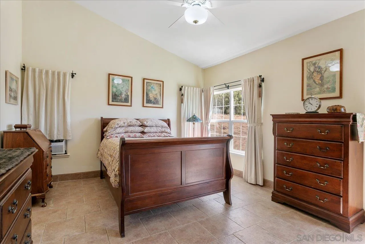13669 Acorn Circle Valley Center, CA 92082 - Photo 25 of 33 a bedroom with a bed and wooden floor