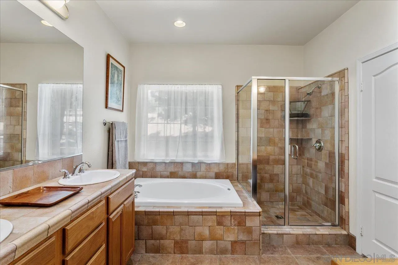 13669 Acorn Circle Valley Center, CA 92082 - Photo 26 of 33 a bathroom with a granite countertop sink a toilet and shower