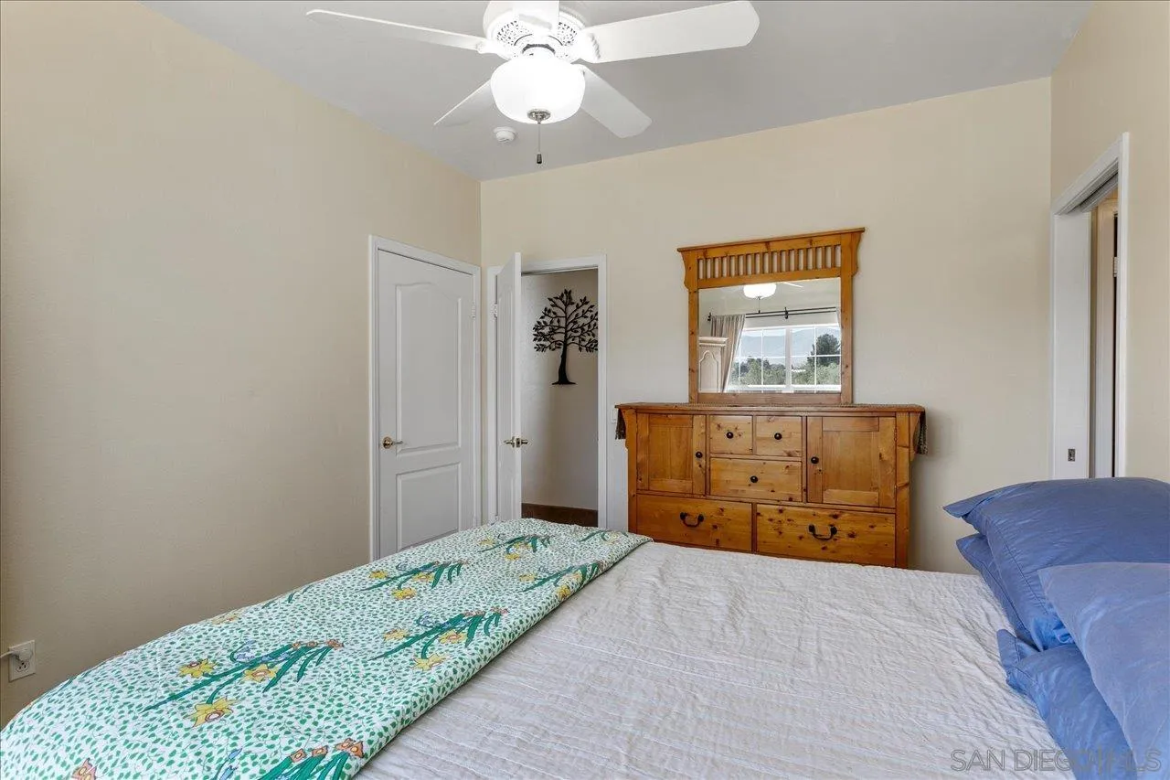 13669 Acorn Circle Valley Center, CA 92082 - Photo 28 of 33 a bedroom with a bed and a dresser