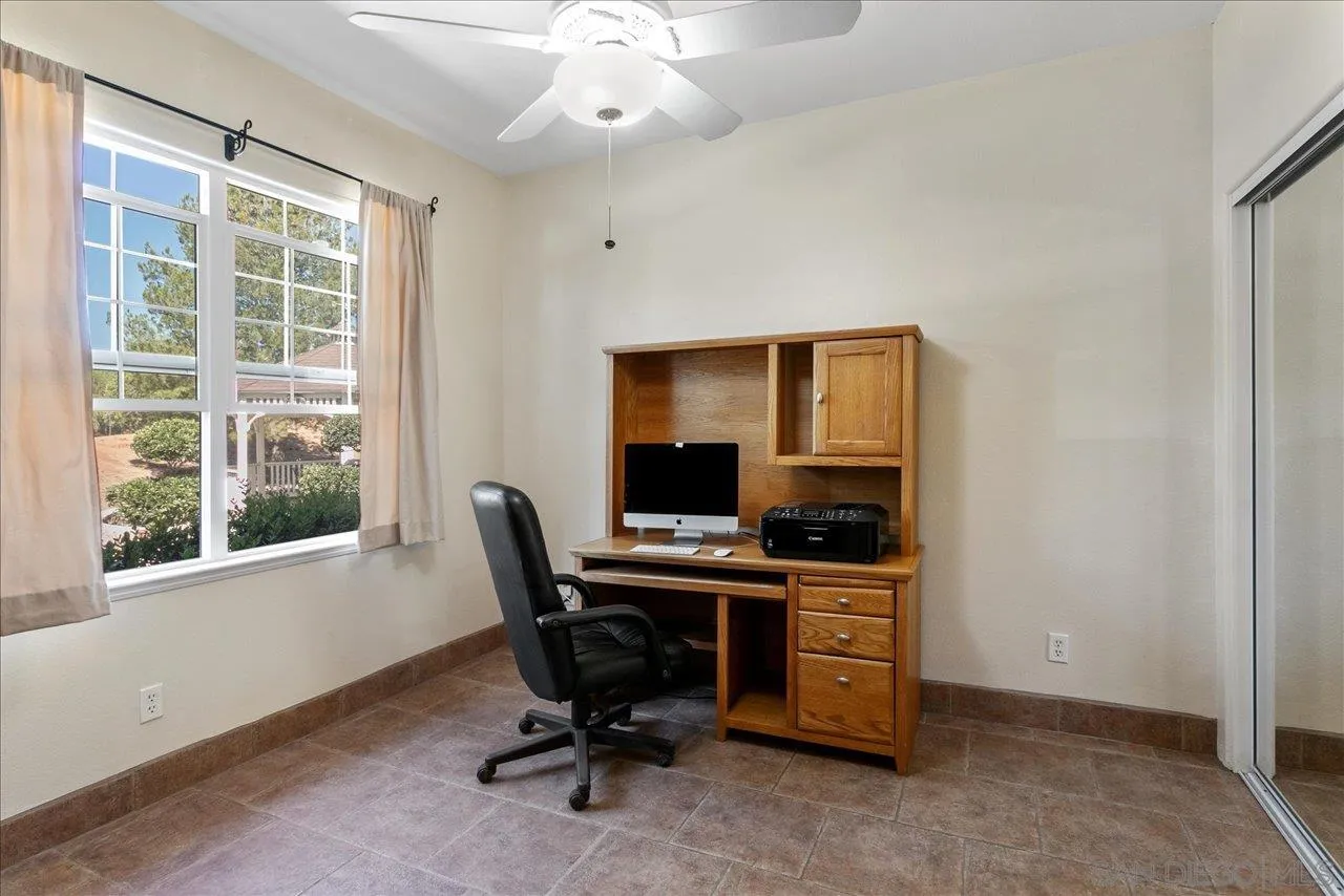 13669 Acorn Circle Valley Center, CA 92082 - Photo 29 of 33 a view of a workspace with furniture and a window