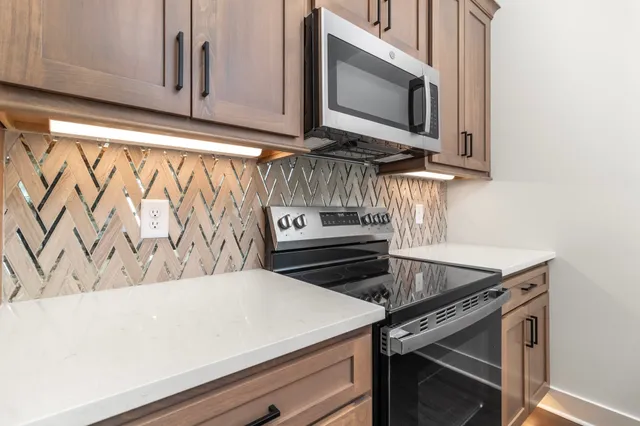 a view of a kitchen counter top with sink and wooden floor