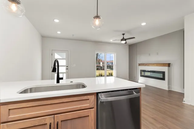 a view of kitchen with refrigerator microwave and stove