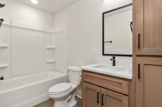 a view of a small space with wooden floor and a window