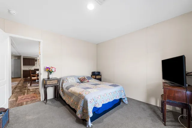 a bedroom with a bed and a chair