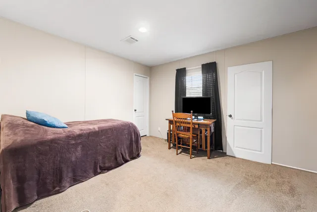 a bathroom with a sink a toilet a mirror and shower curtain