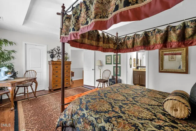 a bed room with a bed and a chair with the potted plant