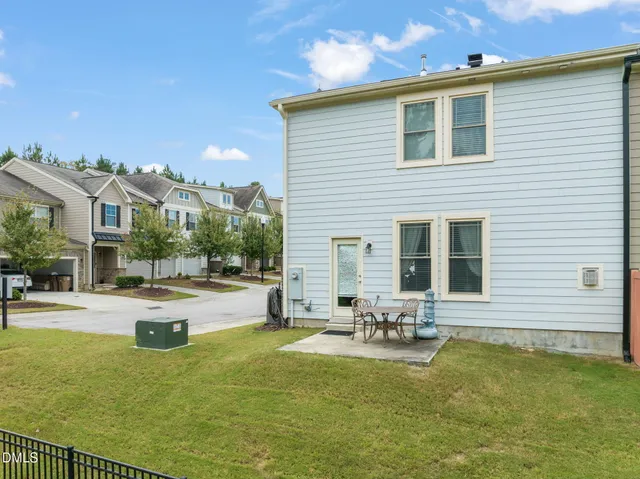 a swimming pool with outdoor seating and yard
