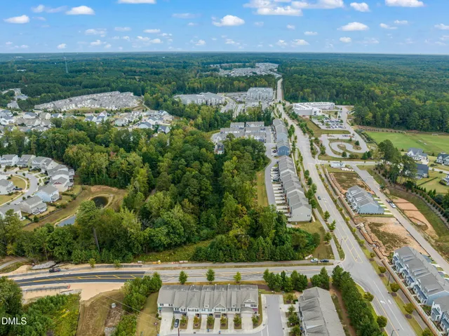 a view of a swimming pool with lawn chairs and plants