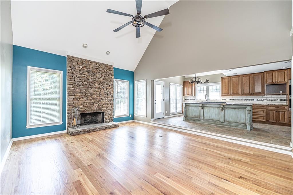 113 Warwick Way Rome, GA 30161 - Photo 9 of 49 a view of an empty room with a kitchen and a fireplace