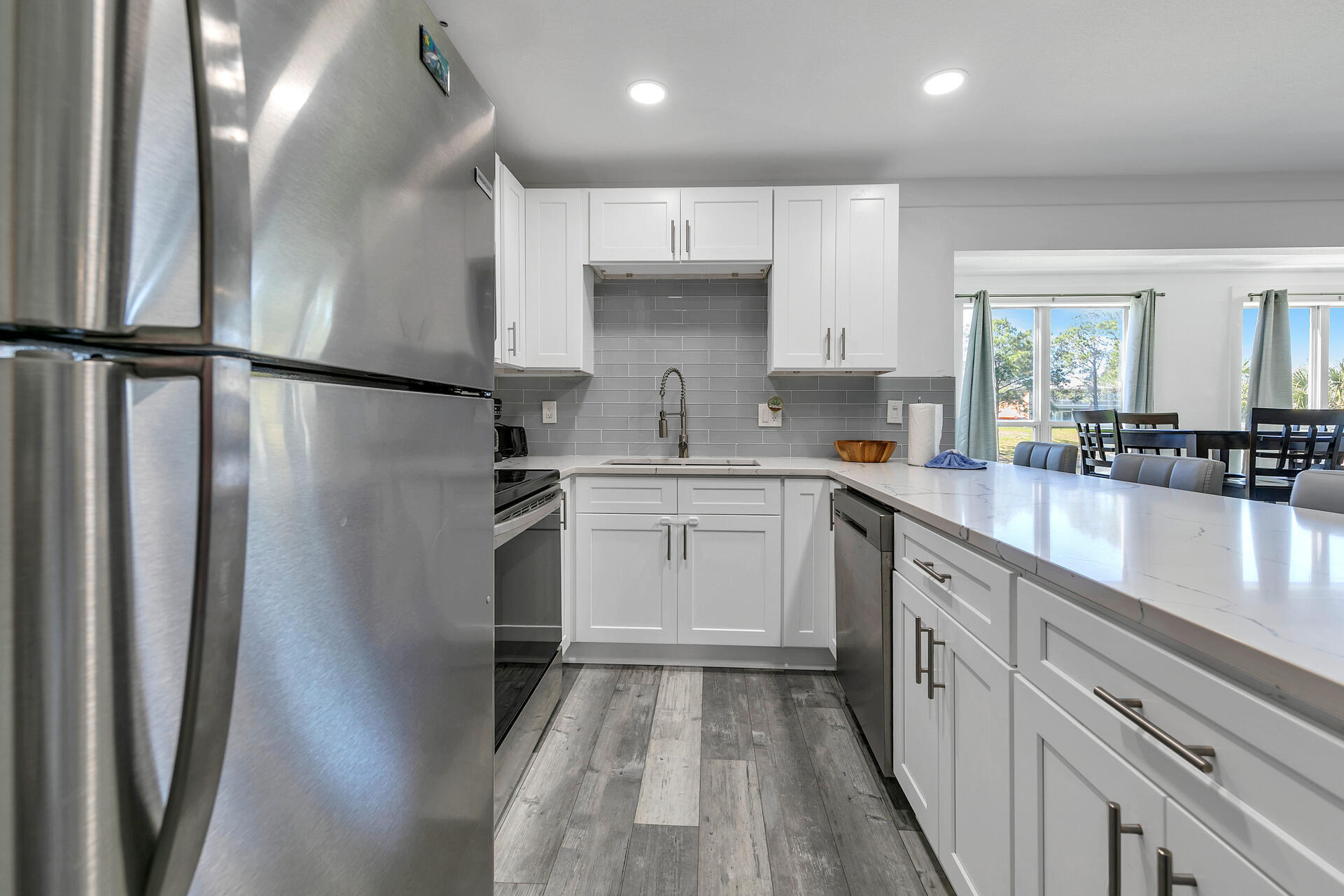 Undisclosed Address Destin, FL 32541 - Photo 13 of 23 a kitchen with a sink stainless steel appliances and cabinets