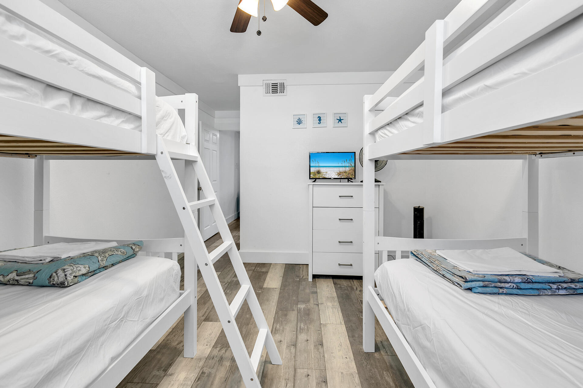 Undisclosed Address Destin, FL 32541 - Photo 16 of 23 a bedroom with a bed and a flat tv screen on dresser