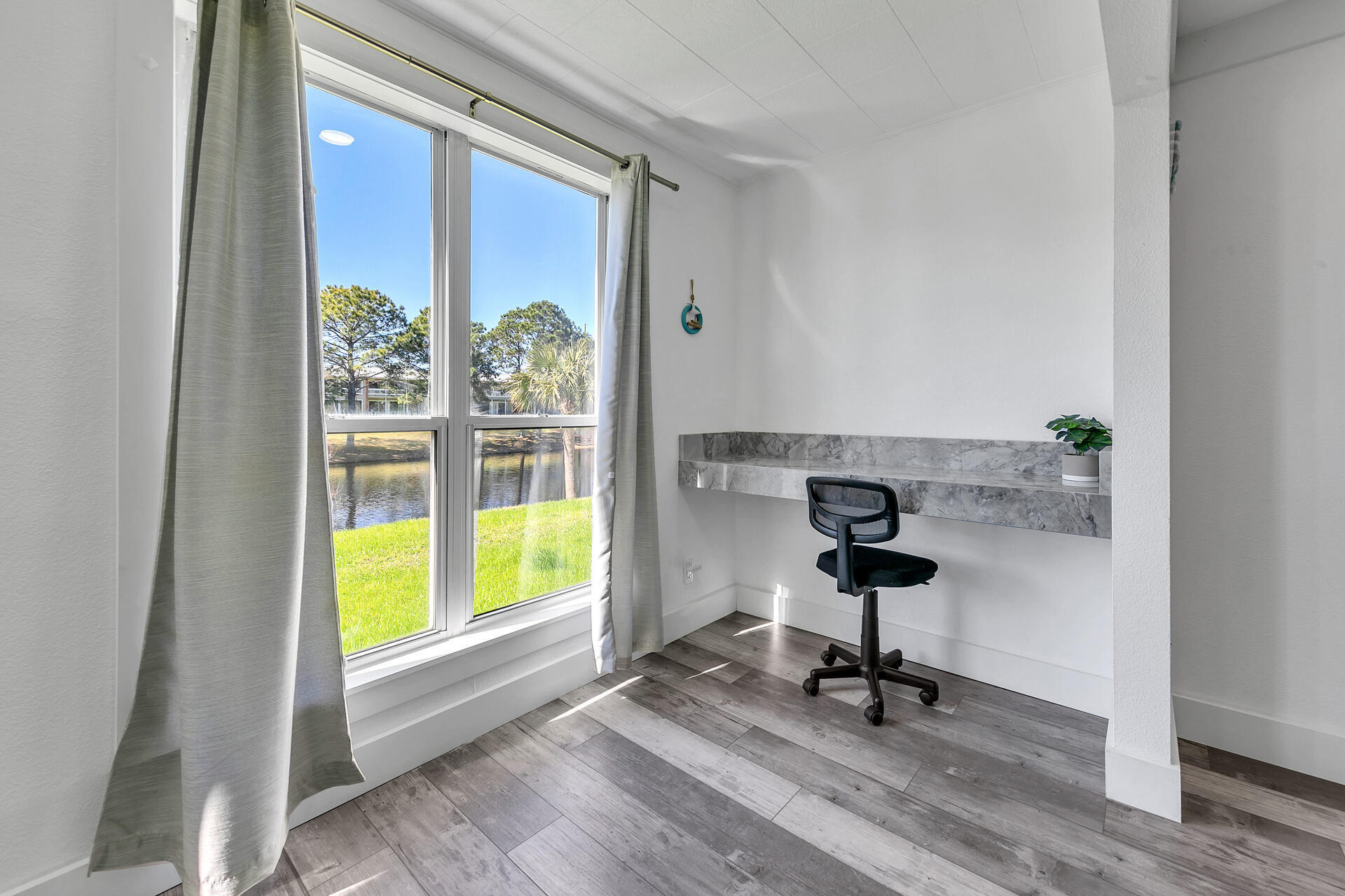 Undisclosed Address Destin, FL 32541 - Photo 6 of 23 a view of a workspace with furniture and a window