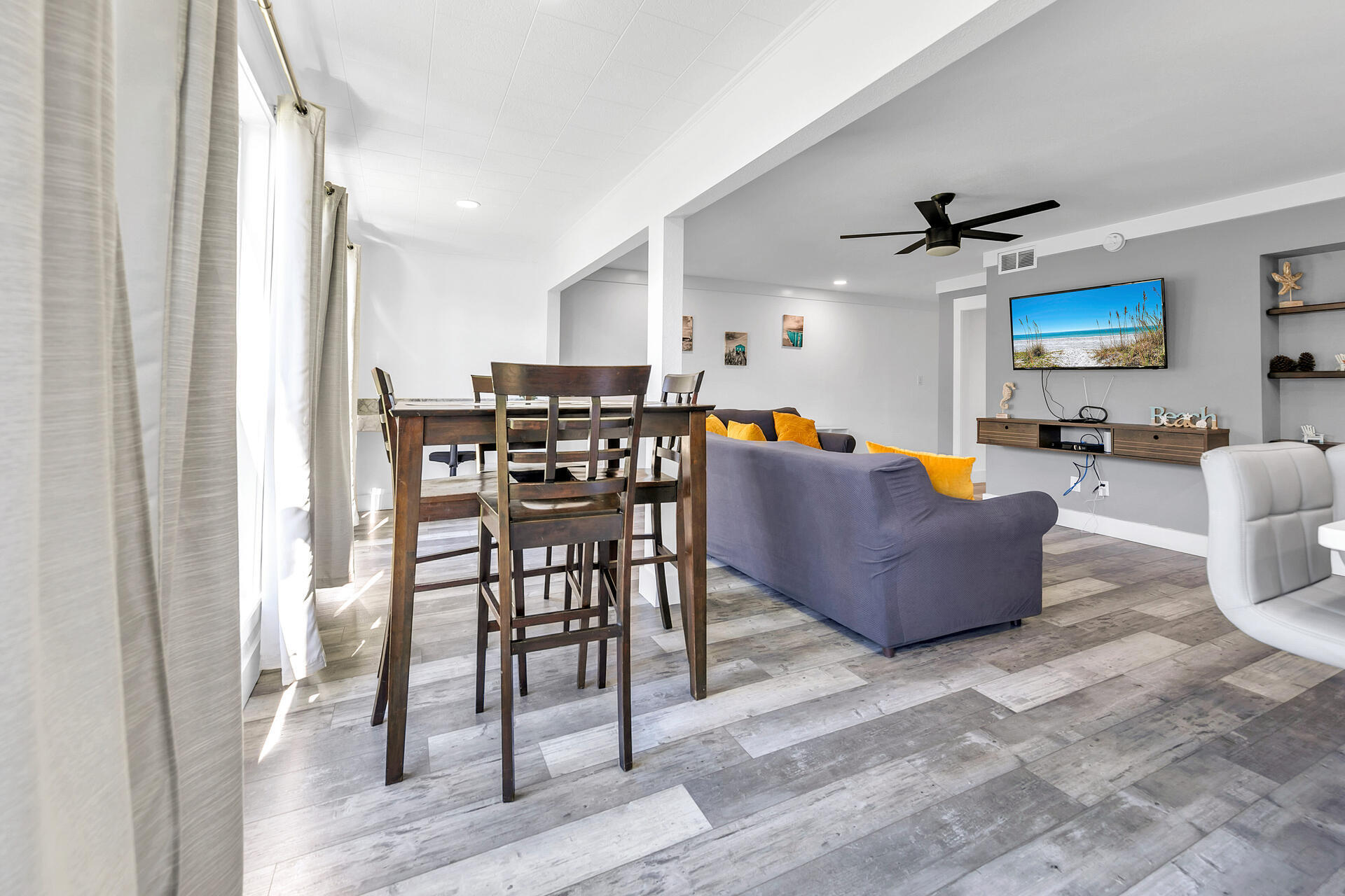 Undisclosed Address Destin, FL 32541 - Photo 8 of 23 a living room with furniture a flat screen tv and a table