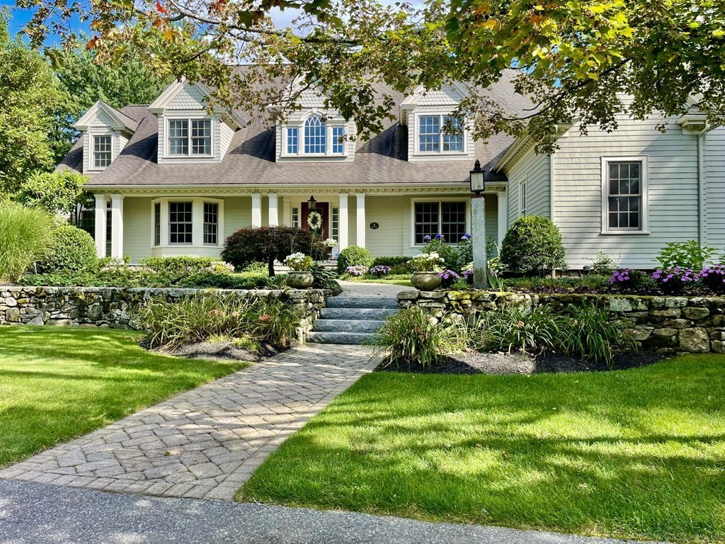 a front view of a house with a yard table and chairs