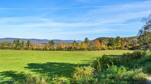 a view of grassy field and mountains
