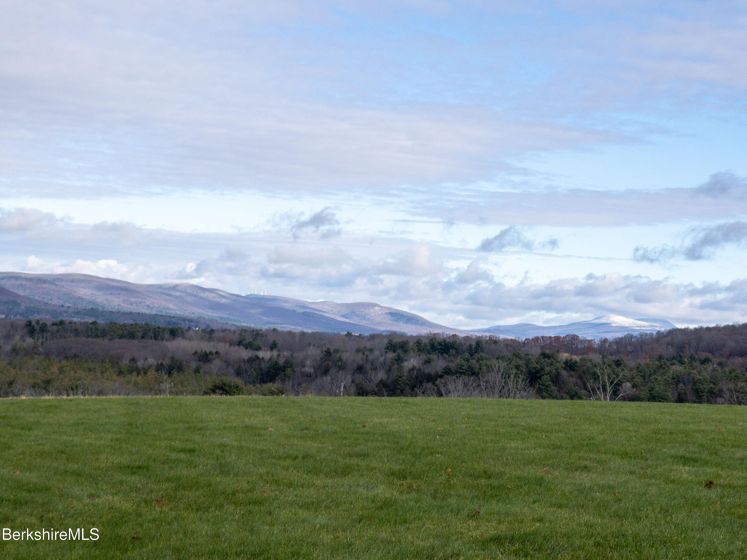 1130 E Road Richmond, MA 01254 - Photo 35 of 53 a view of a grassy field with mountain