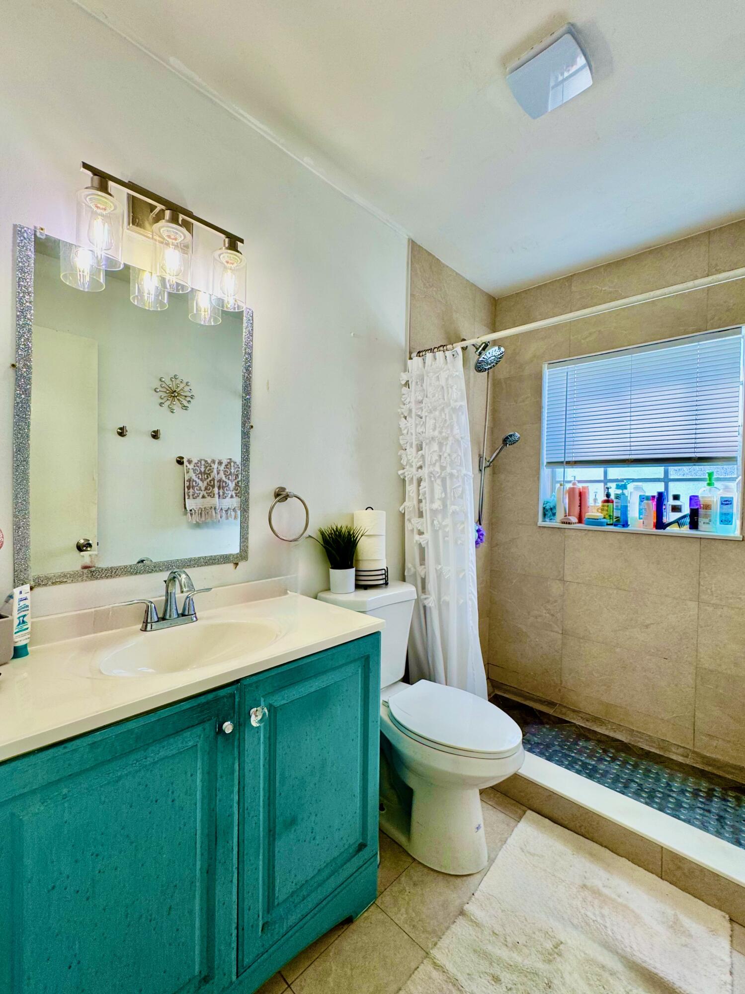 22710 Family Circle Boca Raton, FL 33428 - Photo 25 of 28 a bathroom with a sink and a mirror