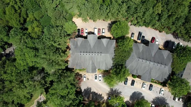 an aerial view of a house with yard and outdoor seating