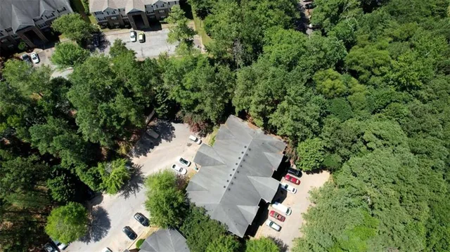 an aerial view of a house with a yard