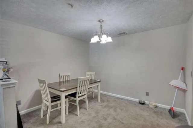 a dining room with a table and chairs