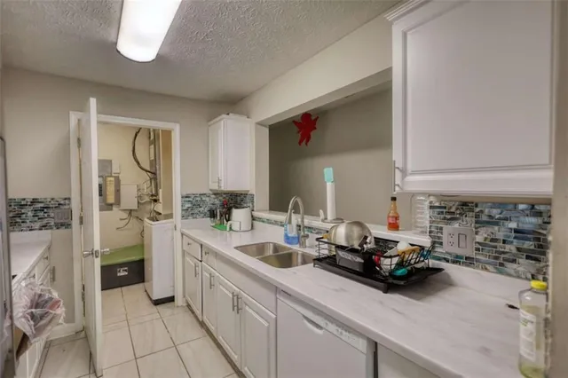 a kitchen with a sink and a refrigerator