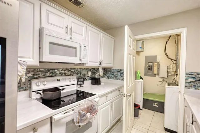 a kitchen with a stove a sink and a microwave