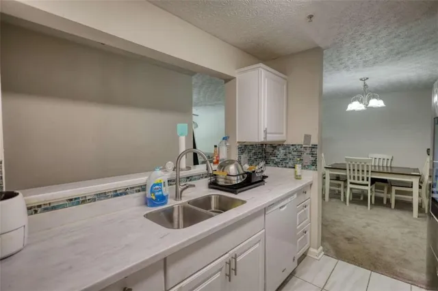 a kitchen with sink and chairs