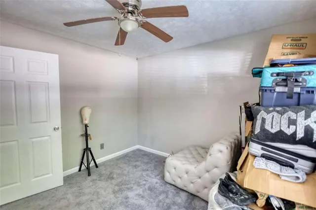 a bedroom with furniture and a chandelier fan