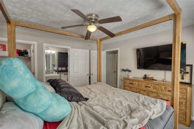 a bedroom with a bed window and a flat screen tv
