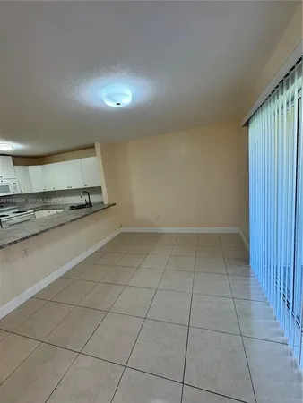 an empty room with a wooden floor and window