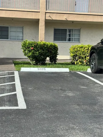 a view of a house with a yard and many windows