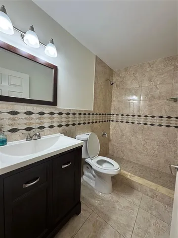 a bathroom with a sink toilet and mirror