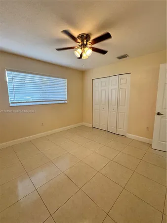 a view of a livingroom with a ceiling fan and a chandelier fan