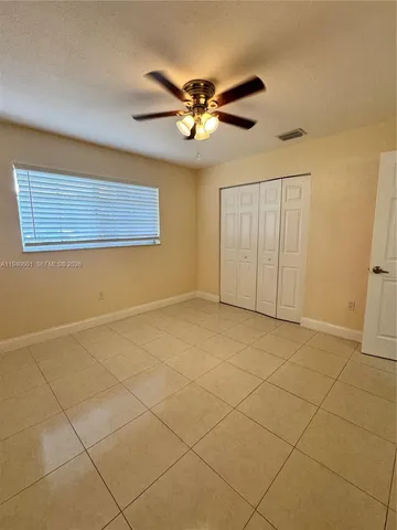 a view of a livingroom with a ceiling fan and a chandelier fan