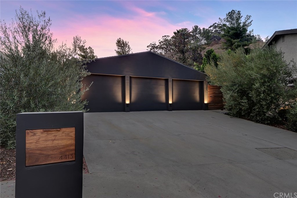 4413 Grimes Place Encino, CA 91316 - Photo 1 of 26 a house that has a tree in front of it