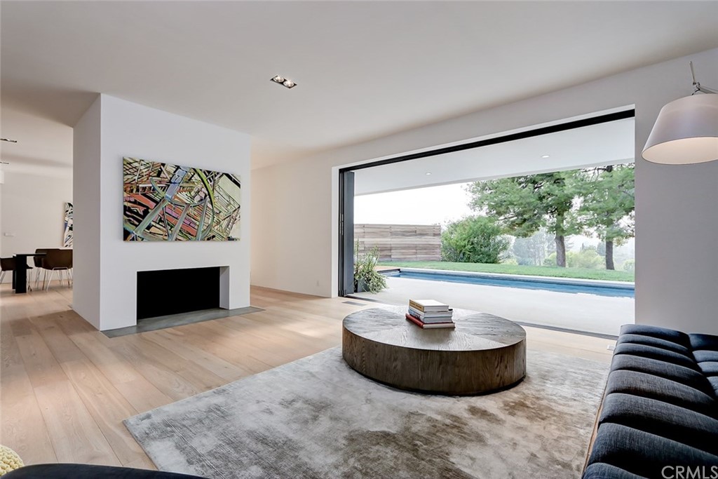 4413 Grimes Place Encino, CA 91316 - Photo 13 of 26 a living room with furniture and a fireplace