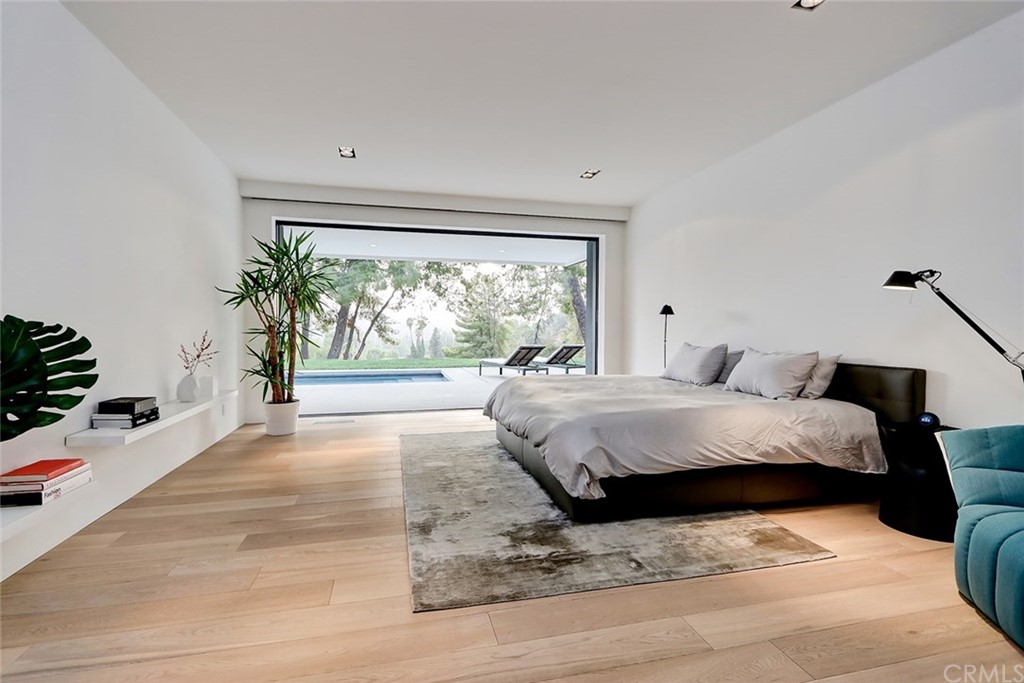 4413 Grimes Place Encino, CA 91316 - Photo 14 of 26 a bedroom with a bed and a large window