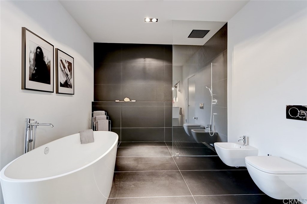 4413 Grimes Place Encino, CA 91316 - Photo 15 of 26 a bathroom with a bathtub and a shower