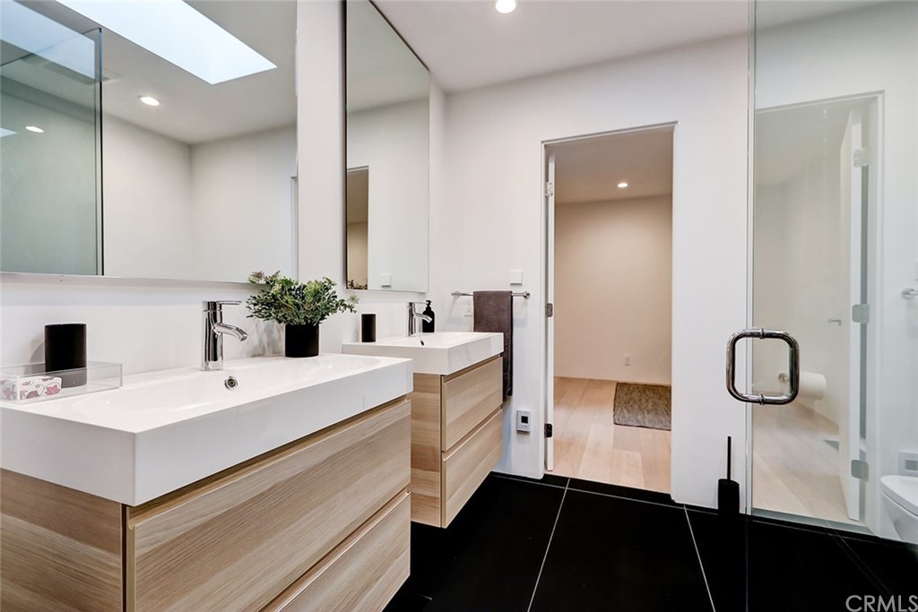 4413 Grimes Place Encino, CA 91316 - Photo 18 of 26 a bathroom with a sink and a mirror